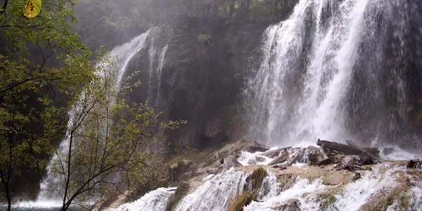 A waterfall with trees in the background