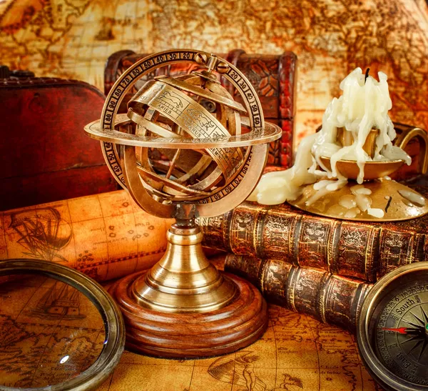 A globe and some other items on top of a table.